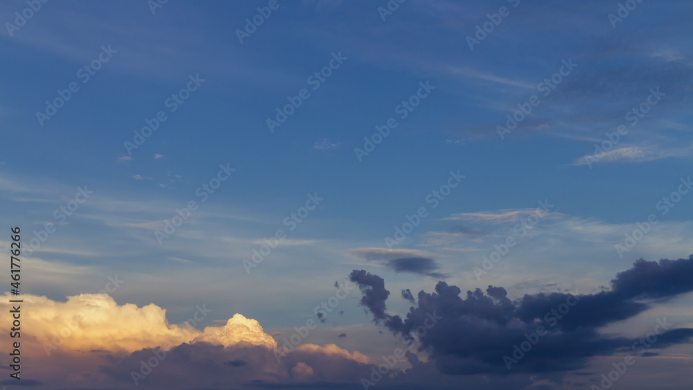 cloudy sky with golden and pink tint of clouds at sunset