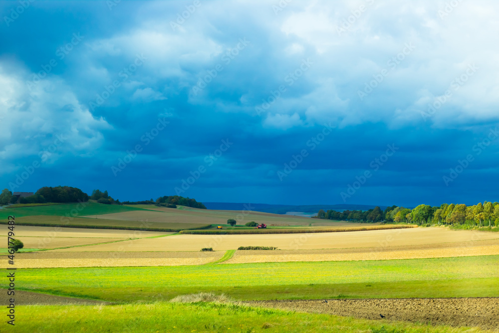 landscape with field and sky before thunder