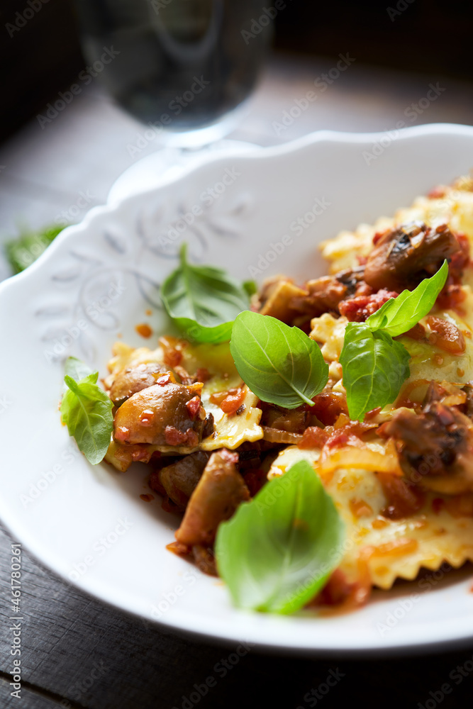 Ravioli with mushrooms and fresh basil. Dark wooden background. Close up Ravioli with mushrooms and fresh basil. Dark wooden background. Close up