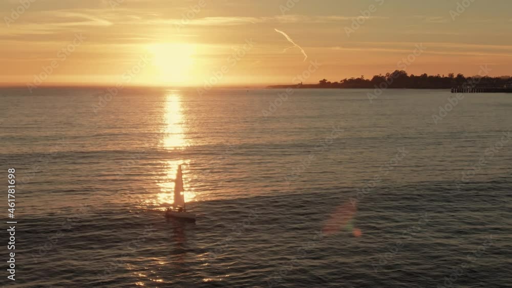 Aerial: Sailboat on the ocean at sunset. Santa Cruz, California, USA Aerial: Sailboat on the ocean at sunset. Santa Cruz, California, USA