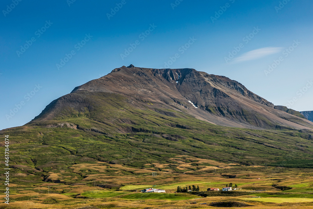 summer road trip on an open high way in Route 1 in Iceland with dramatic mountain landscape on the background.