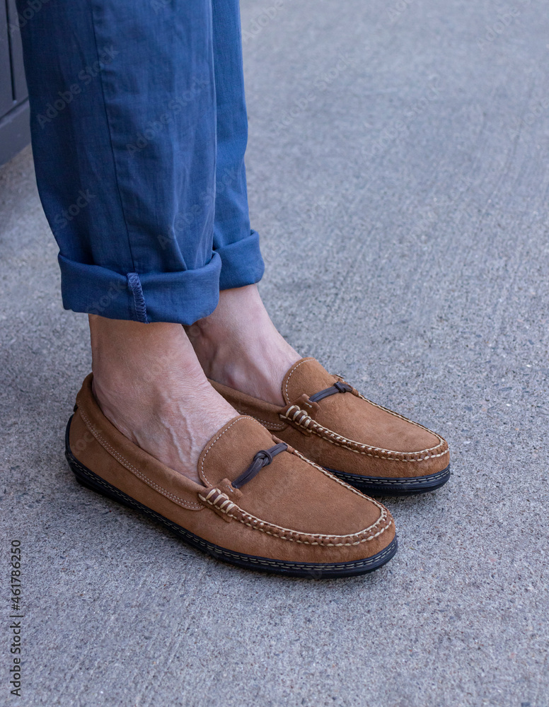 Man in blue pants wearing a pair of traditional leather suede fabric bit drivers for a mens footwear lifestyle.