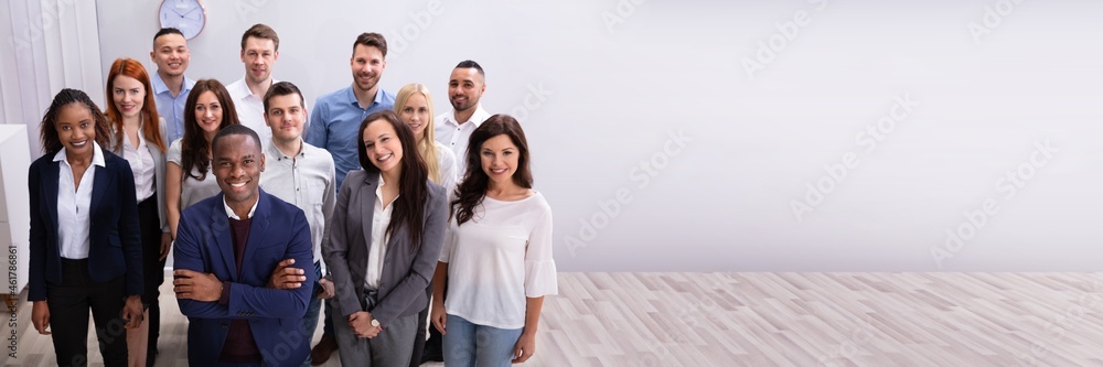 Group Of Smiling Businesspeople Standing In Office Group Of Smiling Businesspeople Standing In Office