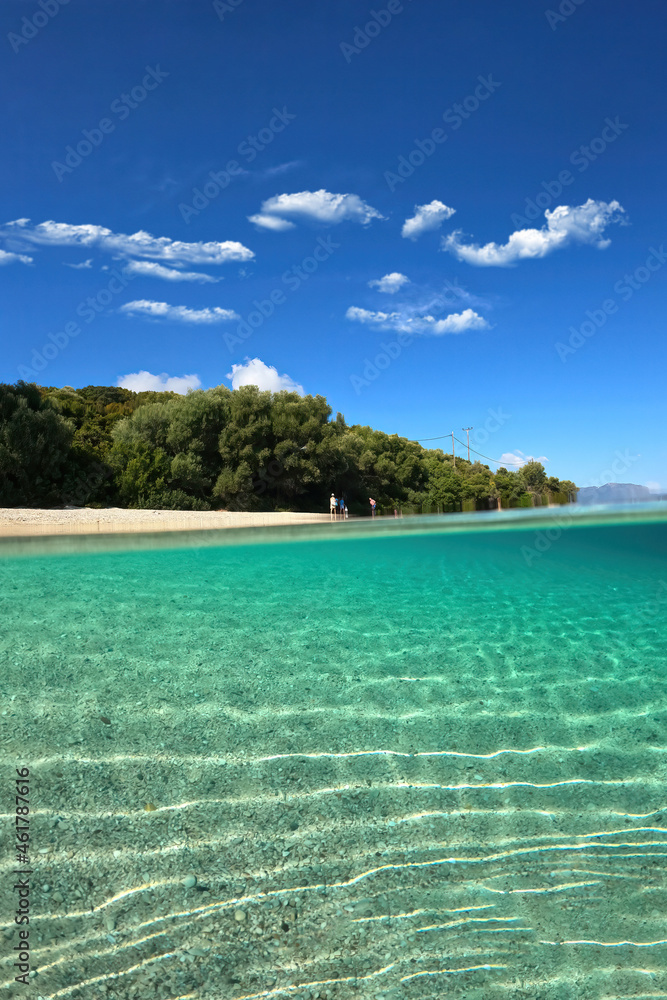 Underwater split photo of famous bay and sandy turquoise beach of Fanari with crystal clear calm sea and rich aquatic life in Ionian island of Meganisi, Greece