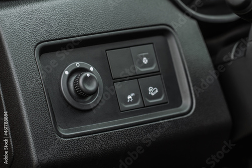 Side mirrors control panel on side door. Car driver adjust side mirror controller. Side mirror control button for adjusting the side mirrors. © Roman