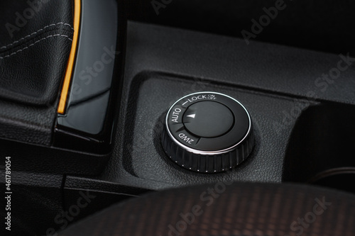 Drive selector button. Automatic gear lever and gear shift. Car interior, offroad drive controller closeup view. Wheel drive selectiob. Four-Wheel Drive transmission selection system. photo