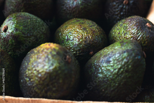 A box of avocados at the market
