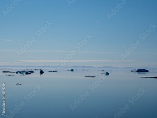 photos of mountains, glaciers, icebergs, and sea ice in the Canadian Arctic landscape. 