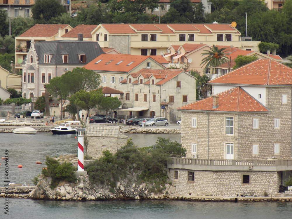 Obraz premium A Lighthouse Navigation Tower in a Village in Montenegro Near Kotor in the Montenegro Fjiord