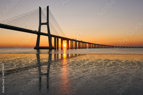 Fototapeta Naklejka Na Ścianę i Meble -  Long exposure shot of Vasco da Gama bridge in Lisbon at sunrise