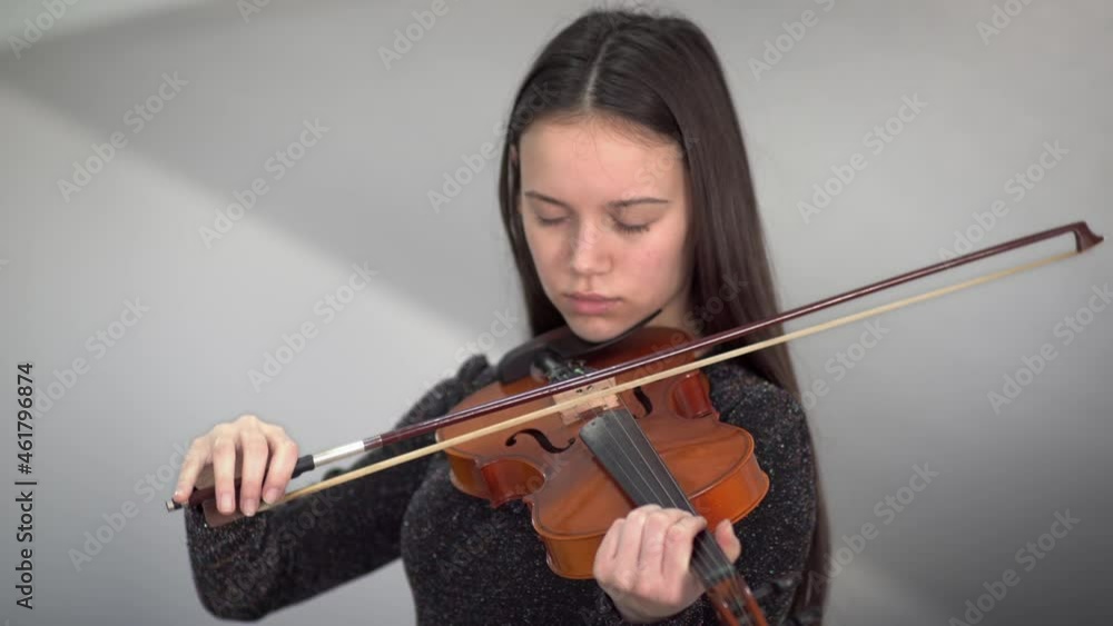 The little girl playing violin,at studio music room,with happy feeling The little girl playing violin,at studio music room,with happy feeling