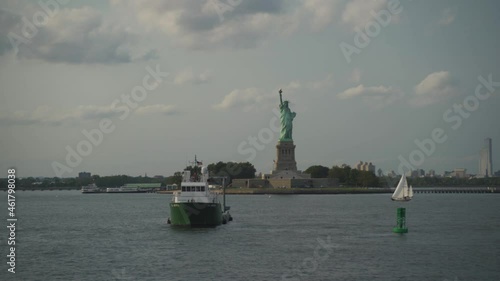 Statue of liberty and sailing boat at the sunset. Travel industry, democracy and freedom concept