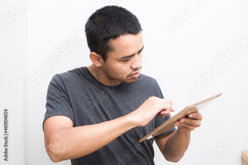 Business asian man use ipad tablet computer standing