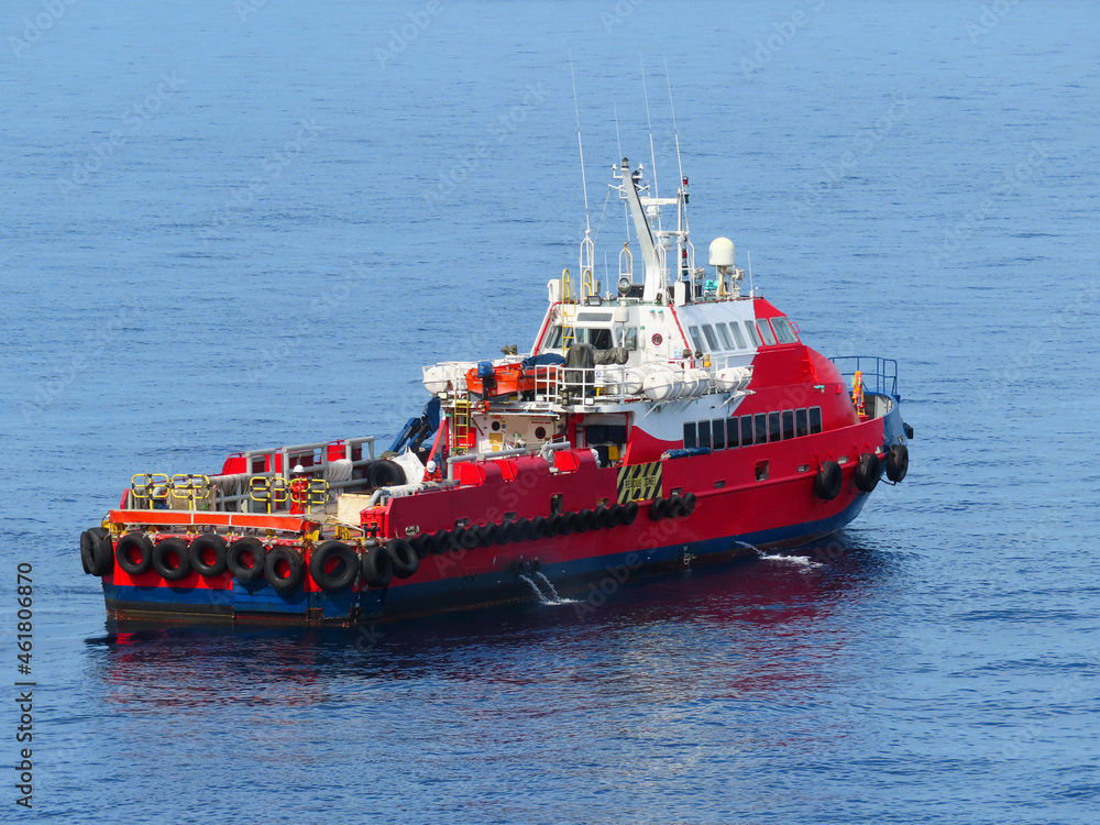 Supply boat transfer the cargo for supporting oil and gas industry and moving cargo from the boat to the platform. Boat is waiting transfer cargo and crews to platform. Supply boat transfer the cargo for supporting oil and gas industry and moving cargo from the boat to the platform. Boat is waiting transfer cargo and crews to platform.