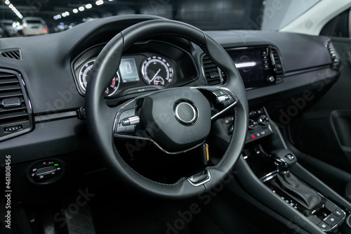 Salon of a new stylish car, steering wheel , dashboard with speedometer, tachometer and other setting buttons. © Виталий Сова
