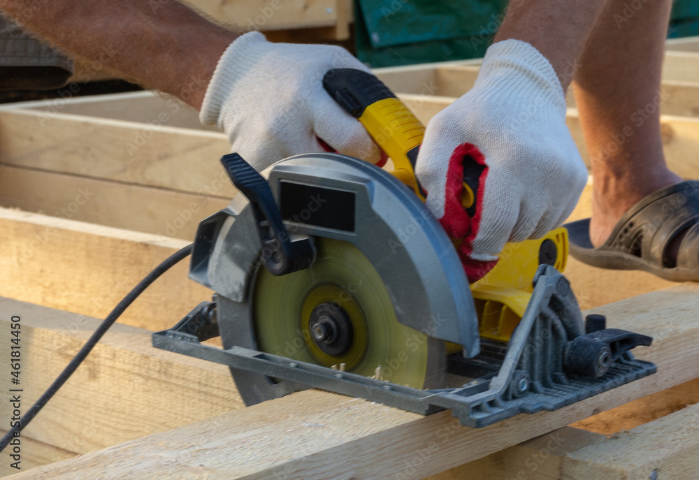 sawing wood with a circular saw sawing wood with a circular saw