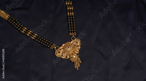 Mangalsutra or Golden Necklace to wear by a married hindu women, arranged with beautiful backgrond. Indian Traditional Jewellery.