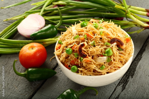 Bowl of delicious Indian breakfast dish,  semiya, vermicelli upma, uppuma, traditional recipes background.