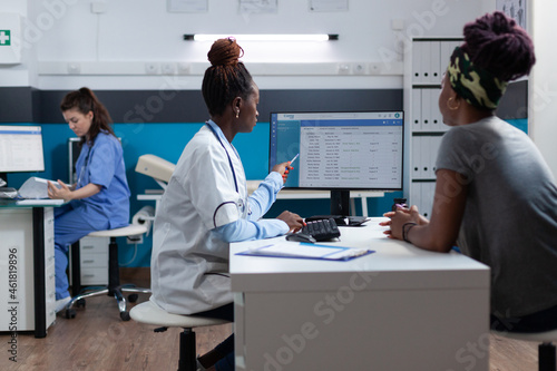 African american therapist doctor examining sickness expertise discussing medication treatment with sick patient during clinical appointment. Practitioner woman working in hospital office