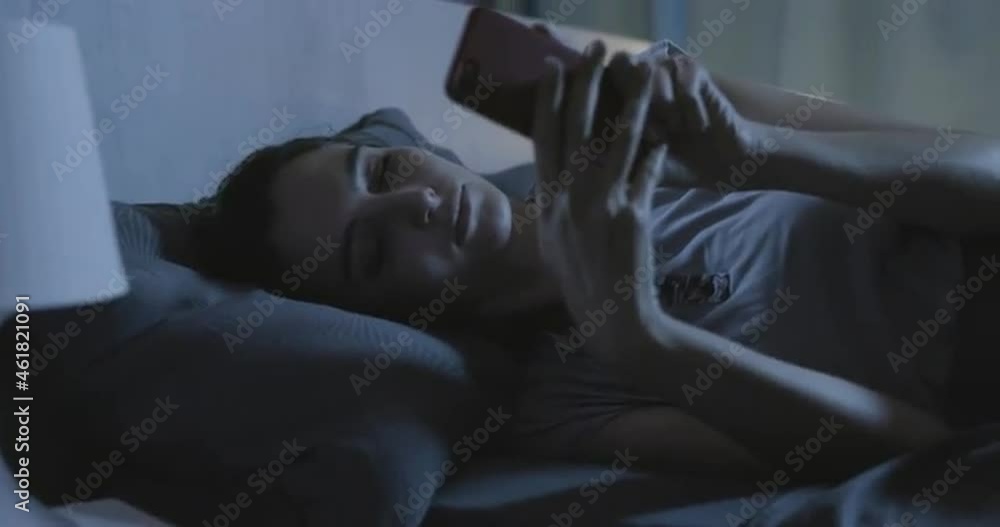 Smartphone alarm waking up a woman Smartphone alarm waking up a woman