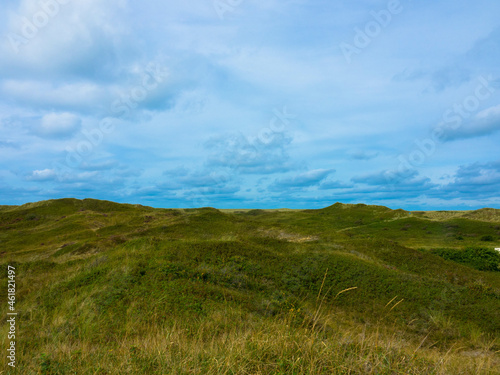 Panoramic view of summer landscape with slopes and small hilly on the dunes of Texel salt marsh area National Park, Dutch North sea coastline, De Koog, Texel Island, Noord Holland, Netherlands