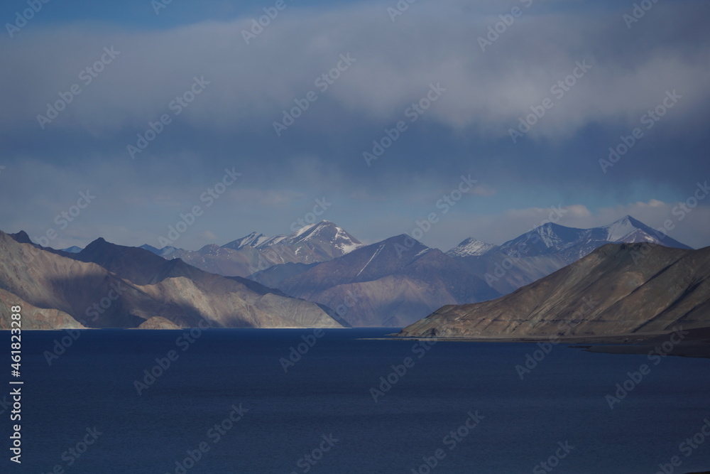 Valley of Himalayan mountains with mountain lake on track to Everest base camp. High mountains with snow-capped peaks. Beautiful mountain landscape..The