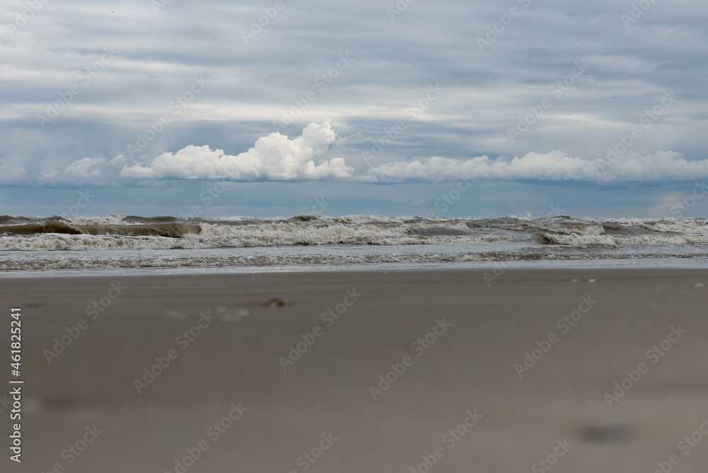 Winter seashore with clouds and waves