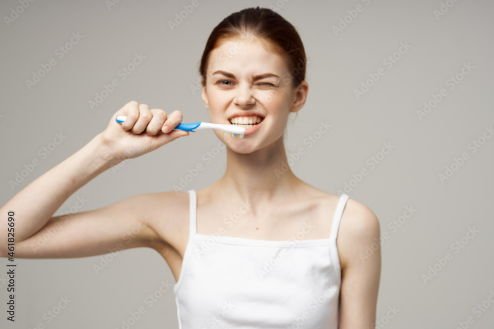 woman in white t-shirt dental hygiene health care studio lifestyle woman in white t-shirt dental hygiene health care studio lifestyle