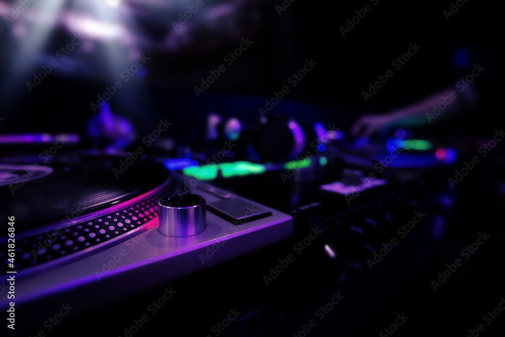 Dj equipment at nightclub, mixer and turntable with record, colored image  with copyspace Photos | Adobe Stock