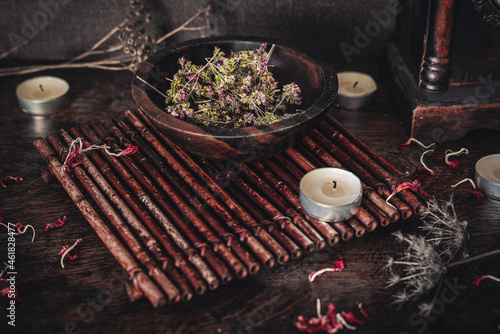 Fototapeta Naklejka Na Ścianę i Meble -  Wooden bowl filled with dried thyme on wiccan witch altar for casting a spell. Free space for text in lower left corner.