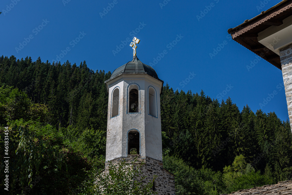 Bell tower of church and trees on the background