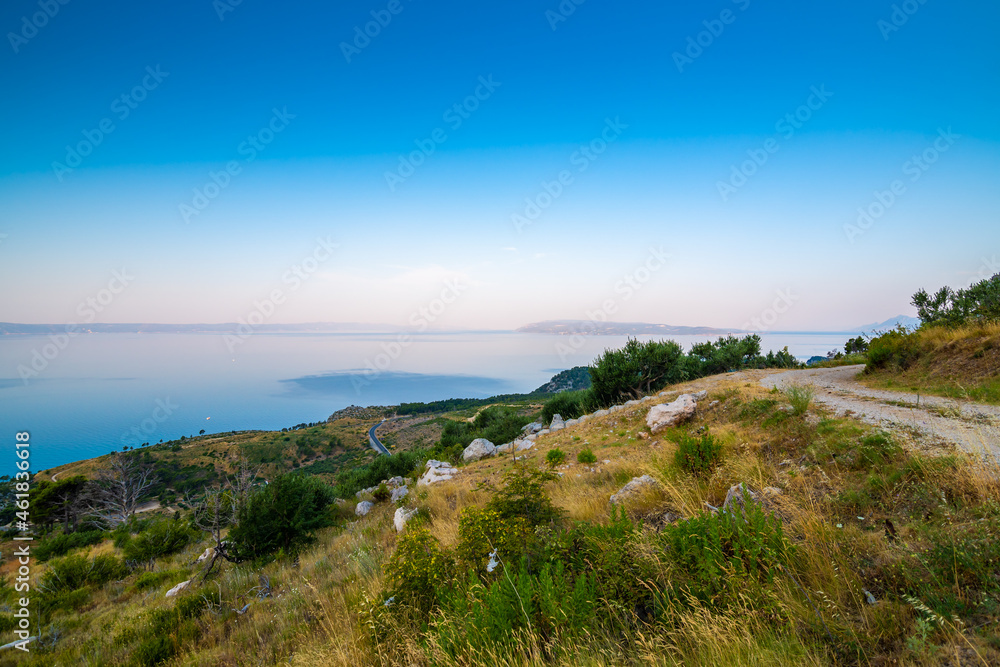 Aerial view of Tucepi town, Croatia. Makarska - Dalmatia region. View of city, sea and isle ind the background. Sunrise time. Aerial view of Tucepi town, Croatia. Makarska - Dalmatia region. View of city, sea and isle ind the background. Sunrise time.