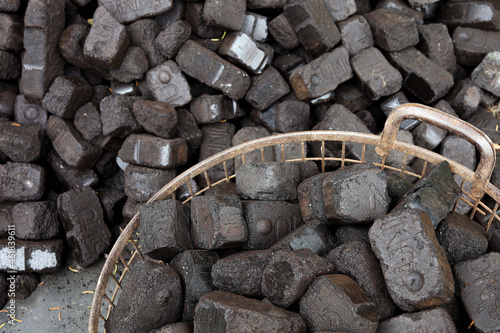 Closeup view of black charcoal, coal briquets. Energy resource, heating, industrial use. photo