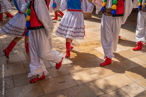 Dancers in Ukrainian colorful folk costumes at Montblanc folk festival in Spain, view with the red shoes