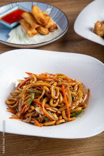 Vertical image of the restaurant table. Yaki udon plate