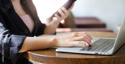 E learning concept. Casual business woman using laptop computer and smartphone working or study online