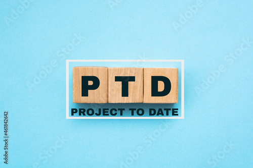 PTD - Project To Date acronym - text on wooden cubes, on light blue background photo