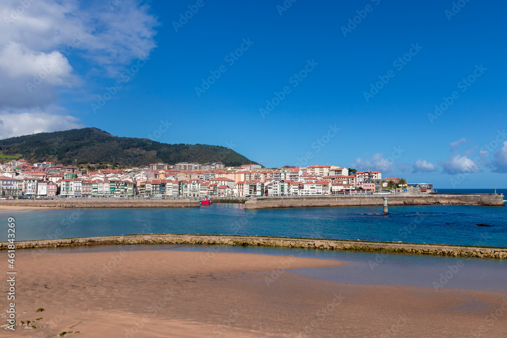 port of lekeitio from the beach with blue sky a sunny winter day
