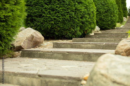 Staircase made of stone in the park. Path in the garden.