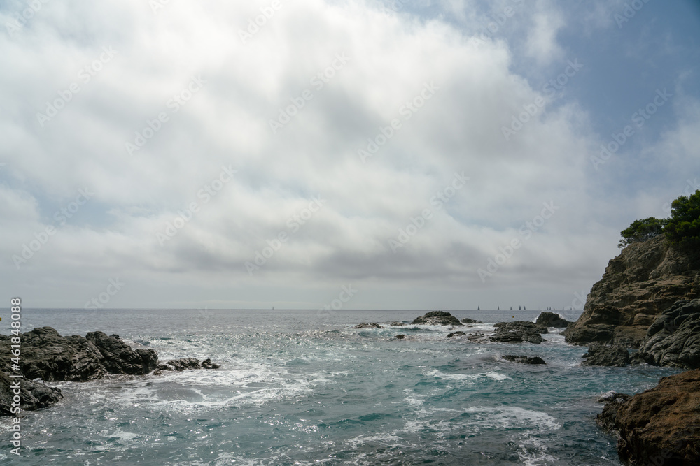 sea beach and rocks with cloudy skies