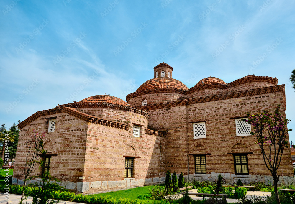 Nicaea (iznik), Turkey. Islamic art museum, made of red bricks wall and its exhibition garden with gravel ground with ancient graves made of marble stones with roman ruins and remains