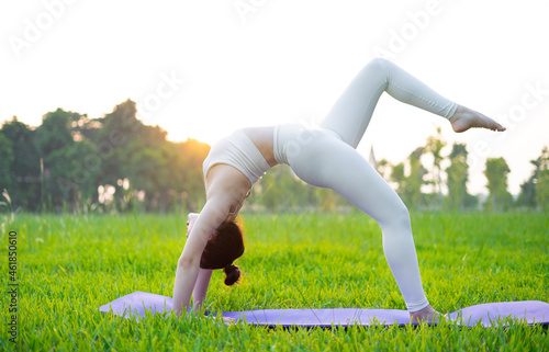 image of asian woman doing yoga outdoors