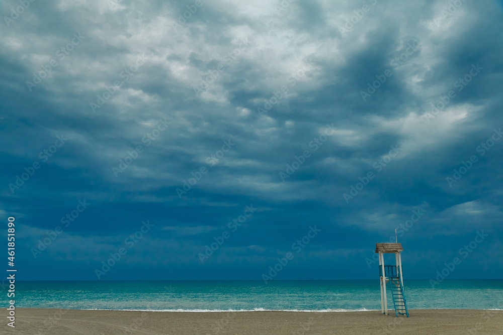 Lookout tower on a beach waiting for the storm Lookout tower on a beach waiting for the storm