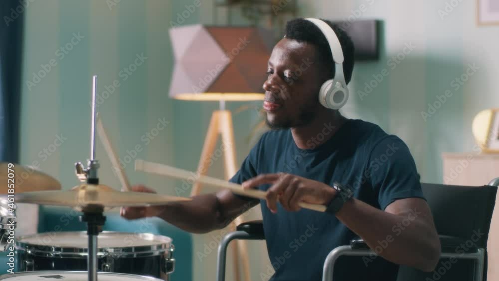 Handicapped African American man learning to play drums Handicapped African American man learning to play drums