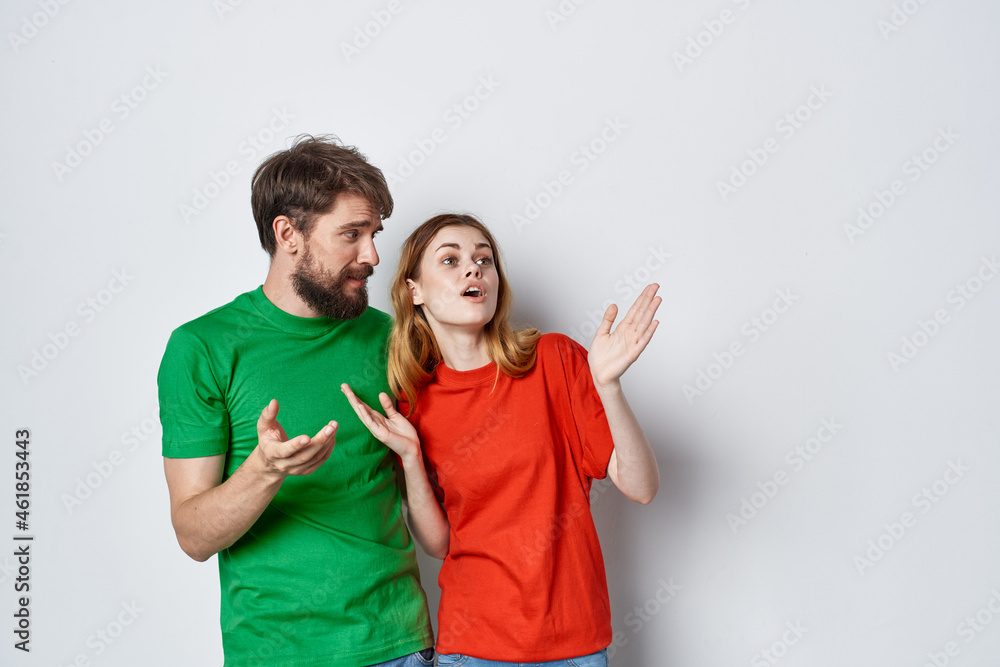married couple multicolored t-shirts communication quarrel light background married couple multicolored t-shirts communication quarrel light background