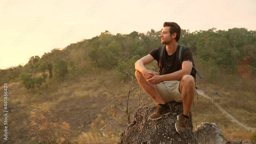 Success Hiker man sitting on the top mountain enjoy in nature watching a nice sunrise after hiking to goal . achievement adventure .Traveler Man relaxation emotional . calm on cliff and sun set Success Hiker man sitting on the top mountain enjoy in nature watching a nice sunrise after hiking to goal . achievement adventure .Traveler Man relaxation emotional . calm on cliff and sun set