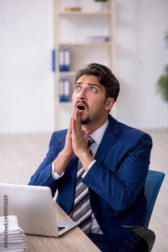 Young male employee working in the office