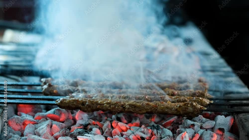 Traditional Turkish Adana Kebab and Adana Kebap. Kebab or kebap on metal skewer barbecue in the kebap restaurant. Traditional Turkish Adana Kebab and Adana Kebap. Kebab or kebap on metal skewer barbecue in the kebap restaurant.
