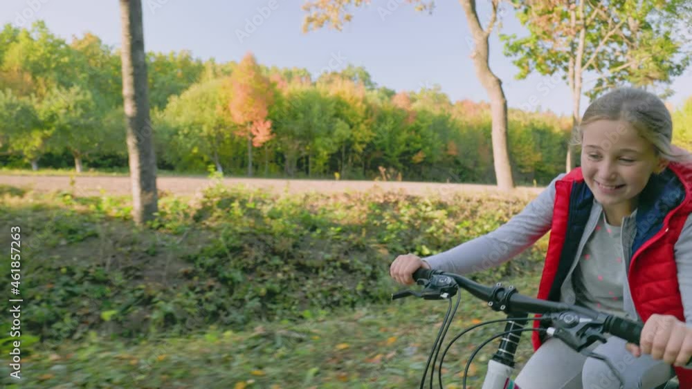 girl riding a bike in the autumn forest girl riding a bike in the autumn forest