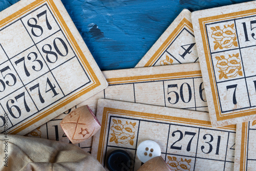 Family Lotto board game. Cards and barrels with numbers. Play at home on a cold winter day or in a new pandemic environment. Bingo game. Gambling . flat lay